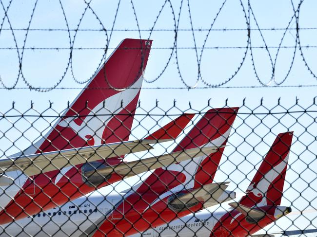 Grounded Qantas aircraft are seen parked at Brisbane Airport in Brisbane, Friday, April 17, 2020. The Australian government has forced airline carriers to cut both their domestic and international flights in order to slow the spread of the coronavirus (COVID-19) disease. (AAP Image/Darren England) NO ARCHIVING