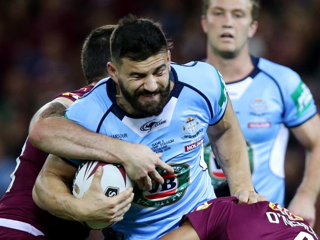 NSW's Josh Mansour attempts to bust the tackle of QLD's Justin O'Neill during State of Origin Game 2 between the NSW Blues and the Queensland Maroons at Suncorp Stadium , Brisbane . Picture : Gregg Porteous