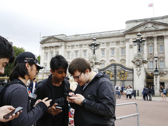 Young gamers play Pokemon Go outside Buckingham Palace, London, England. Picture: Getty