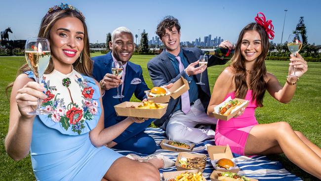 Zana Pali, Niki Simos, Jeffrey Kissuei and Harry Ross enjoying a selection of the best foods on offer at the 2022 Melbourne Cup Carnival. Picture: Jake Nowakowski.