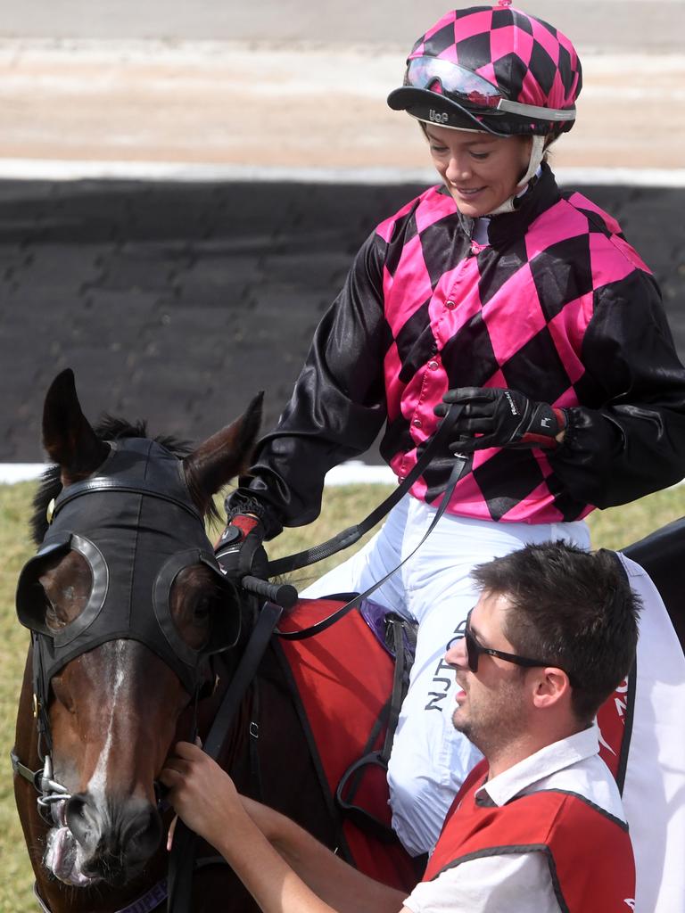 Jockey Sonja Wiseman mounts her horse for the first race at Darwin Ladies Day. Picture: (A)manda Parkinson