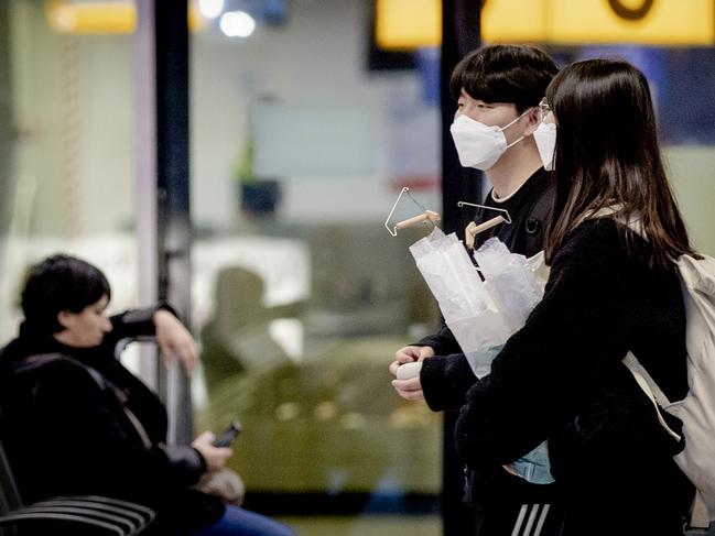 Travellers at Amsterdam Schiphol Airport wear a face mask. Picture: ANP/AFP