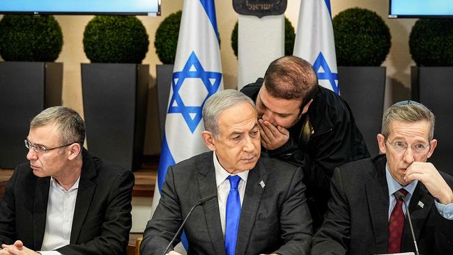 Israel's Prime Minister Benjamin Netanyahu (C) is advised as he chairs a cabinet meeting at the Kirya military base.