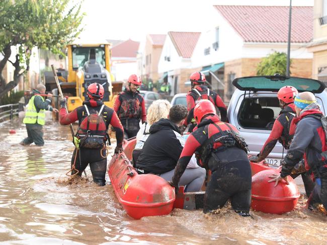 Spanish rescuers taking residents on a dinghy following deadly flooding in Valencia. Picture: AFP