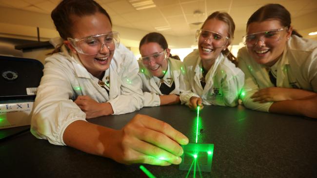 Penelope Crothers, Gabriella Reynolds Campbell, Lara Crouch and Hannah O'Brien, conduct a Young's diffraction experiment at St Margaret’s Anglican Girls School in Brisbane yesterday. Picture: Lyndon Mechielsen