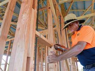 LONE TRADIE: Carpenter Warren McBean frames a house at Royal Sands. Developers of the Bucasia estate say they need at least another four tradies to get ahead of the demand for new houses, that will result in construction starting on a new home every fortnight until the end of June. Picture: Tony Martin