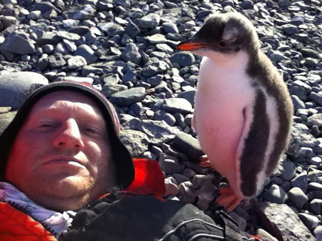 Money shot ... Joel even manages to take a selfie with the penguin. Picture: Picture Media from Caters News