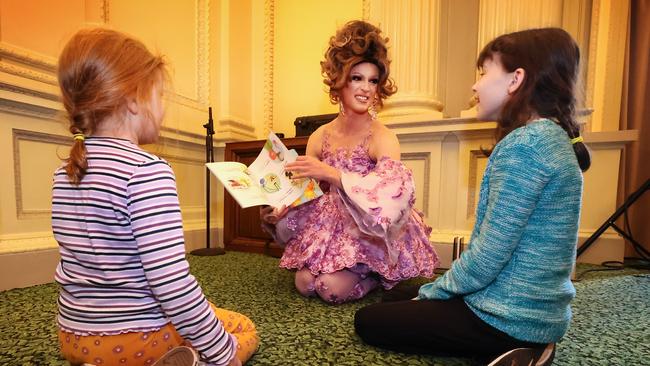 A drag queen reads a story to youngsters. Picture: David Caird