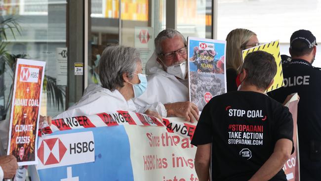 Protesters with banners calling on HSBC to dump Adani's coal outside the Southport branch of the bank. Picture: Glenn Hampson