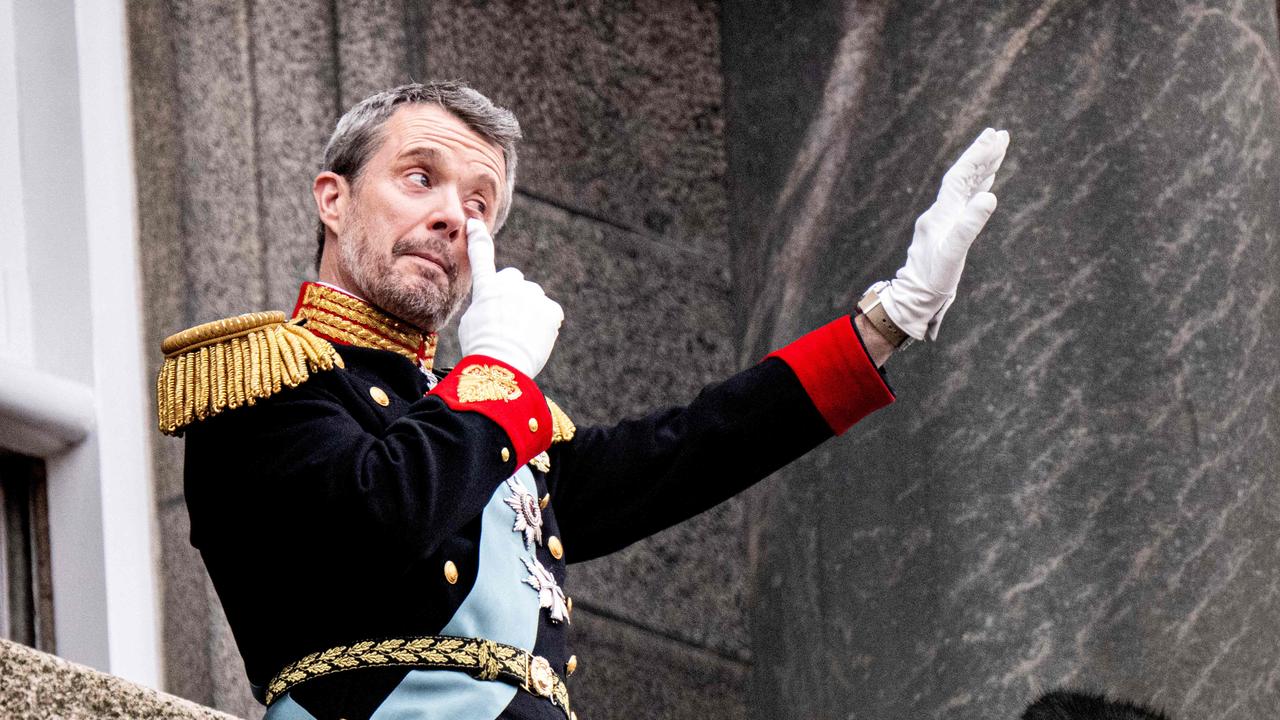 King Frederik waves to the crowd during an emotional moment on the balcony. Picture: Nils Meilvang/Ritzau Scanpix/AFP