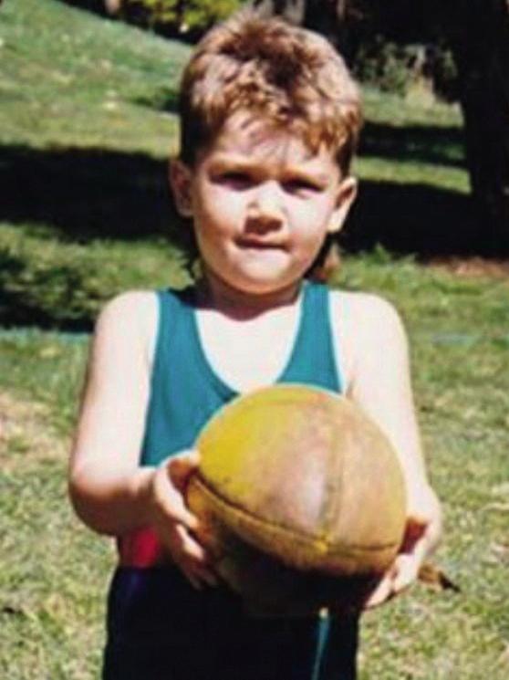 A young Dustin Martin with his footy.