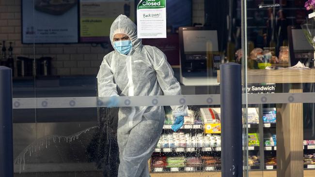 A cleaner at work in the BP service station in Mickleham, which is listed as a Covid exposure site. Picture: David Geraghty