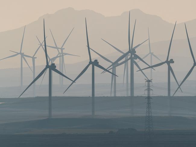 (FILES) This photograph taken on February 13, 2023 shows wind turbines in a wind farm in Fuendejalon, with the Moncayo mount in background, Zaragoza province, northern Spain. Boosted by the rise of artificial intelligence, data centre projects are multiplying in Aragon, a Spanish region at the forefront of renewable energies leading to a boom encouraged by the authorities, who are hoping for major economic spin-offs. (Photo by CESAR MANSO / AFP)