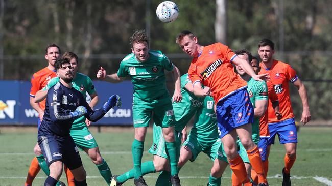 Jake Halliday heads clear for Campbelltown City during its Australian NPL elimination final defeat in Brisbane. Picture: Peter Wallis