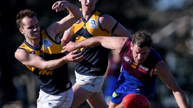 Whittlesea and Banyule players battle for the ball. Picture: Andy Brownbill