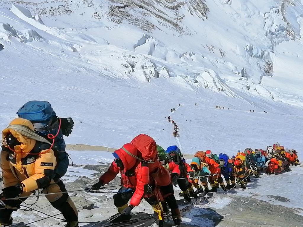 A long queue of mountain climbers line a path on Mt Everest just below camp 4 in Nepal. Seasoned mountaineers say the Nepal government’s failure to limit the number of climbers resulted in dangerous overcrowding and a greater number of deaths. Picture: AP/Rizza Alee