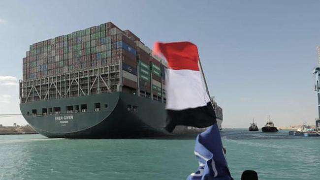 The Egyptian flag gets a celebratory workout as the MV Ever Given is refloated late on Monday. Picture: AFP