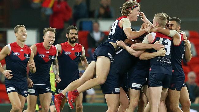 GOLD COAST, AUSTRALIA - MAY 11: Melbourne celebrate the win during the round eight AFL match between the Gold Coast Suns and the Melbourne Demons at Metricon Stadium on May 11, 2019 in Gold Coast, Australia. (Photo by Jono Searle/AFL Photos/Getty Images)