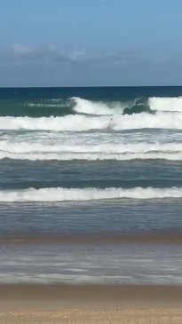 Moment Gold Coast lifeguards rescue man from surf