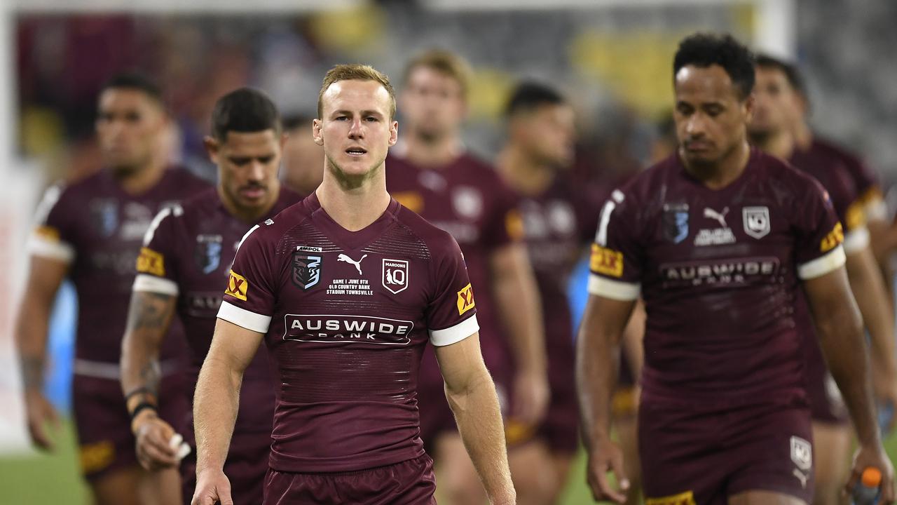 The Maroons walk from the field