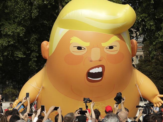 A six-meter high cartoon baby blimp of U.S. President Donald Trump is flown as a protest against his visit, in Parliament Square in London, England, Friday, July 13, 2018. Trump is making his first trip to Britain as president after a tense summit with NATO leaders in Brussels and on the heels of ruptures in British Prime Minister Theresa May's government because of the crisis over Britain's exit from the European Union. (AP Photo/Matt Dunham)