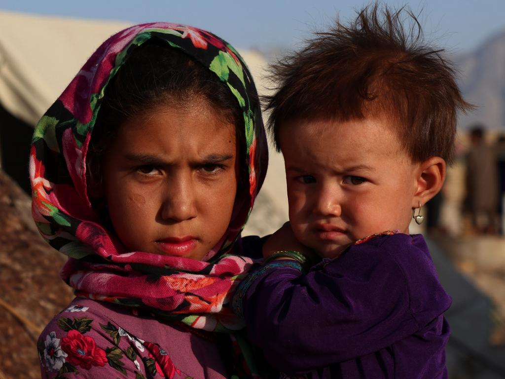 An Afghan girl holds her little sister at a displaced person camp in Mazar-i-Sharif, capital of northern Balkh province, Afghanistan. Picture: Kawa Basharat/Xinhua via Getty Images