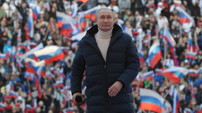 Russian President Vladimir Putin strides out into Luzhniki Stadium in Moscow on March 18, 2022. The puffer jacket he is wearing is valued at $A 17,485. The sweater under it cost another $AU5595. Picture: Mikhail Klimentyev/SPUTNIK/AFP