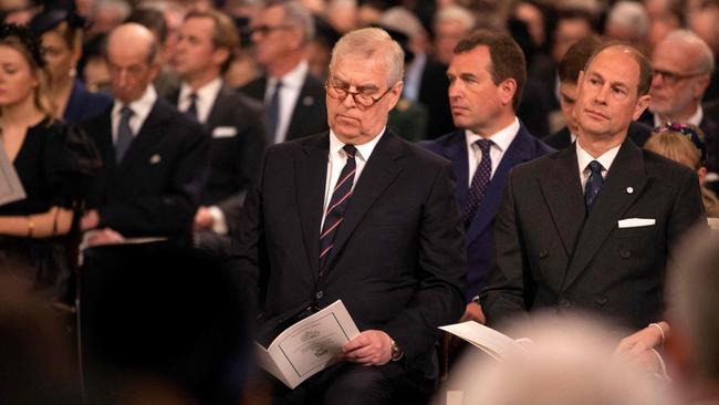 Prince Andrew, Duke of York, centre, sits with his brother Britain's Prince Edward, Earl of Wessex, right, as they attend the Service of Thanksgiving. Royal family members and Palace aides said it was right for the duke to attend, but not to grandstand. Picture: AFP