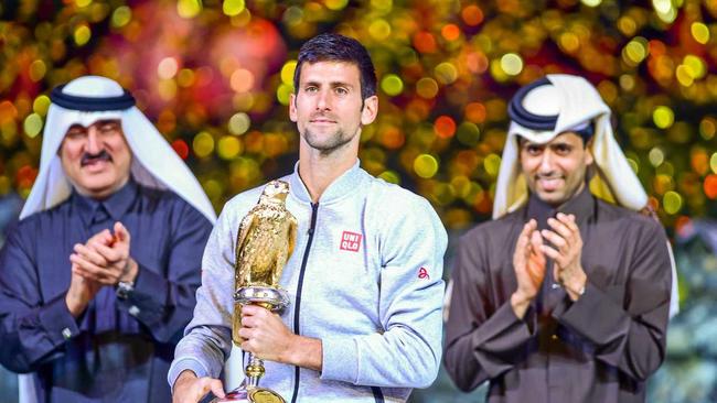 Novak Djokovic of Serbia celebrates with his trophy after winning the Qatar ExxonMobil Open. Picture: Alexandra Panagiotidou