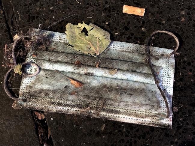 SYDNEY, AUSTRALIA - NewsWire Photos OCTOBER 8, 2020: A discarded disposable COVID-19 coronavirus mask is pictured in the street in Sydney. Picture: NCA NewsWire / Nicholas Eagar