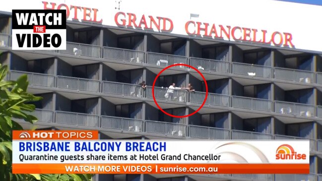 Quarantined visitors seen passing items over balconies at Hotel Grand Chancellor (Sunrise)