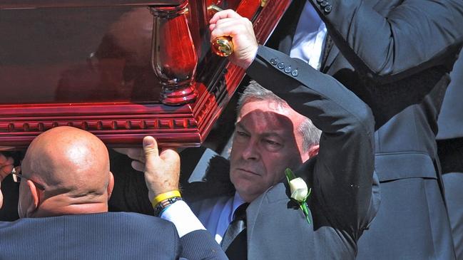 Borce Ristevski carries the coffin of his wife in 2017.