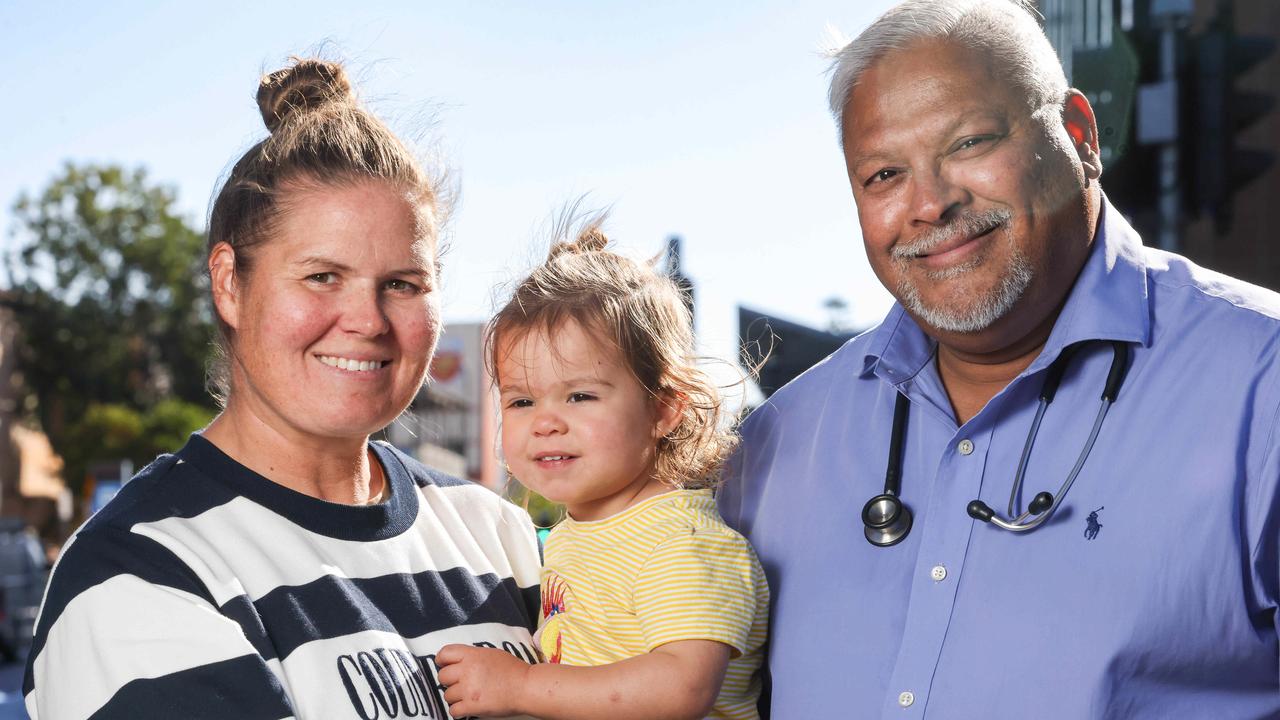 Dr Benjamin D’Souza, CAVUCS medical unit head and a paediatric emergency physician, with Child and Adolescent Virtual Urgent Care consumer Julie Power and her 18-month-old daughter Charlotte. Picture: Russell Millard