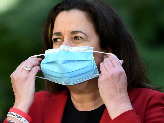 BRISBANE, AUSTRALIA - NewsWire Photos - AUGUST 8, 2021. Queensland Premier Annastacia Palaszczuk puts on her mask during a media conference at Parliament House to provide a Covid-19 update.Picture: NCA NewsWire / Dan Peled