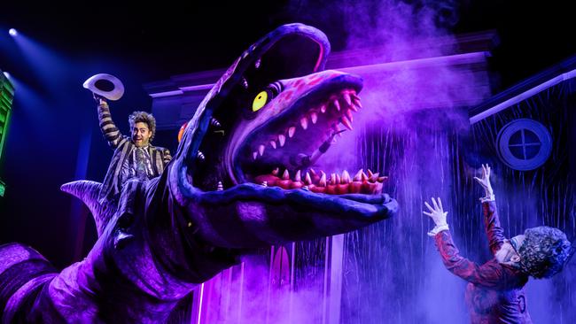 Eddie Perfect rides a sandworm in Beetlejuice The Musical, with Noni McCallum as Juno, below right. Picture: Michelle Grace Hunder.