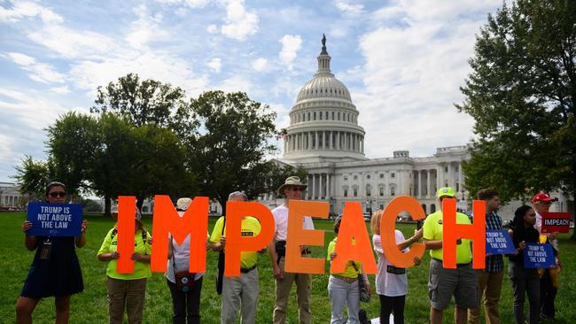 Protesters hold up letters reading "impeach" in front of the US Capitol building during the "People's Rally for Impeachment" on Capitol Hill in Washington, DC. Picture: AFP