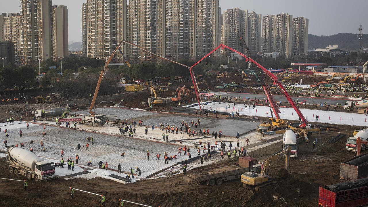 Hundreds of construction workers and heavy machinery at the site of Huoshenshan Hospital in Wuhan on January 28. Picture: Getty Images