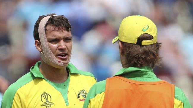 Australia's Alex Carey, left, talks to teammate Adam Zampa during a drinks break after he was hit off the bowling of England's Jofra Archer during the Cricket World Cup semi-final match between England and Australia at Edgbaston in Birmingham, England, Thursday, July 11, 2019. (AP Photo/Aijaz Rahi)