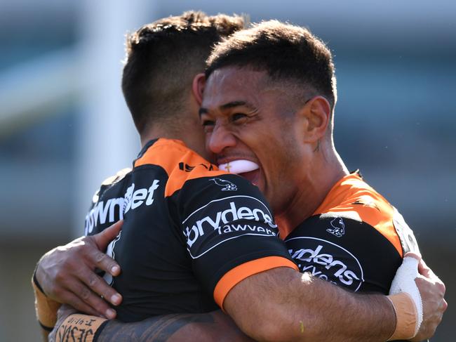 Michael Chee Kam of the Wests Tigers (right) celebrates after scoring a try during the Round 22 NRL match between the Canberra Raiders and the Wests Tigers at GIO Stadium in Canberra, Sunday, August 12, 2018. (AAP Image/Lukas Coch) NO ARCHIVING, EDITORIAL USE ONLY