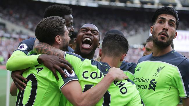 Liverpool's English striker Daniel Sturridge (C) joins the celebration.