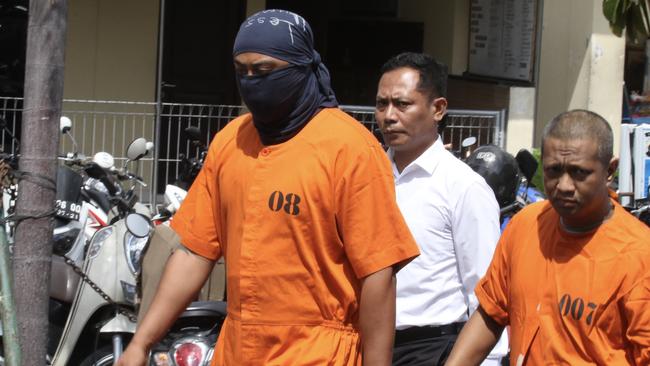 William Cabantog (left) being escorted by police. Picture: Lukman S. Bintoro