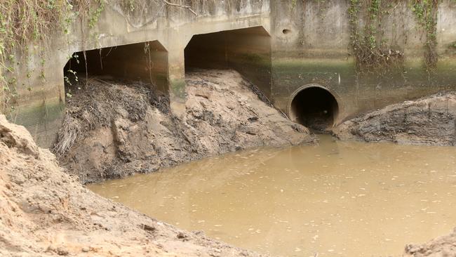 Police search a storm water drain running under Cobalt Road in Carole Park. Picture: Jono Searle