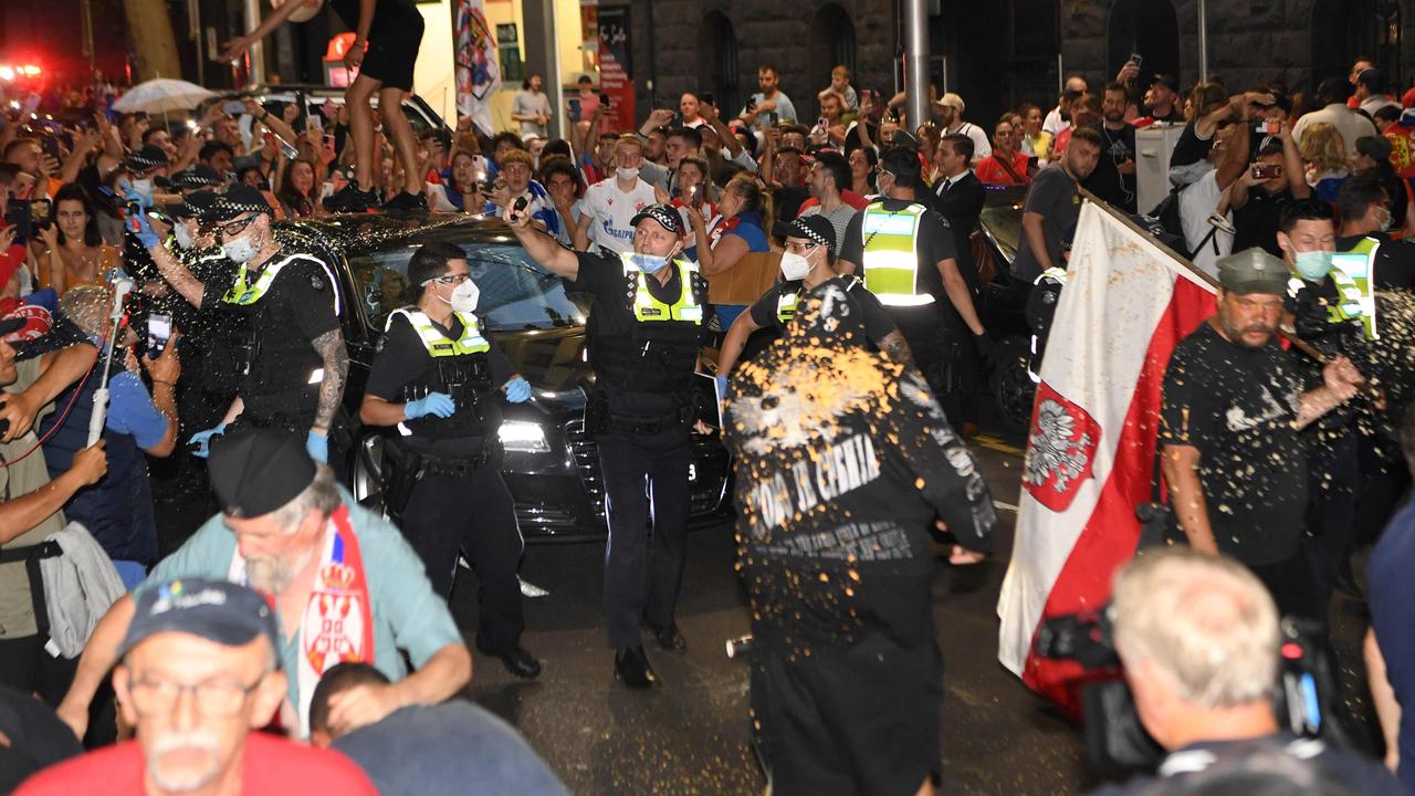 Police officers pepper spray Novak Djokovic supporters. Picture: William West