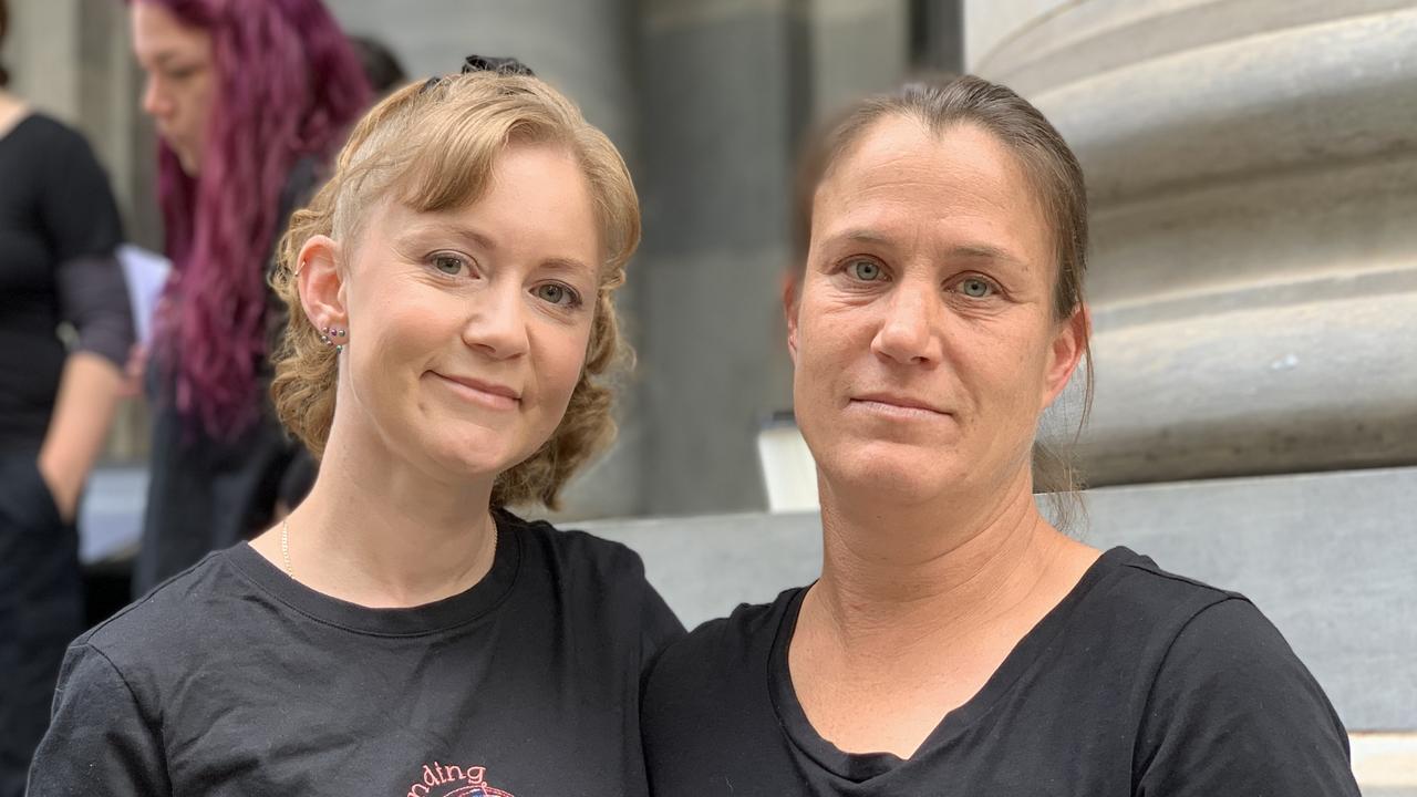 Emma Pollard (left) and Tegan Moran sang together with a choir at the rally against domestic violence at South Australian parliament. Picture: Duncan Evans