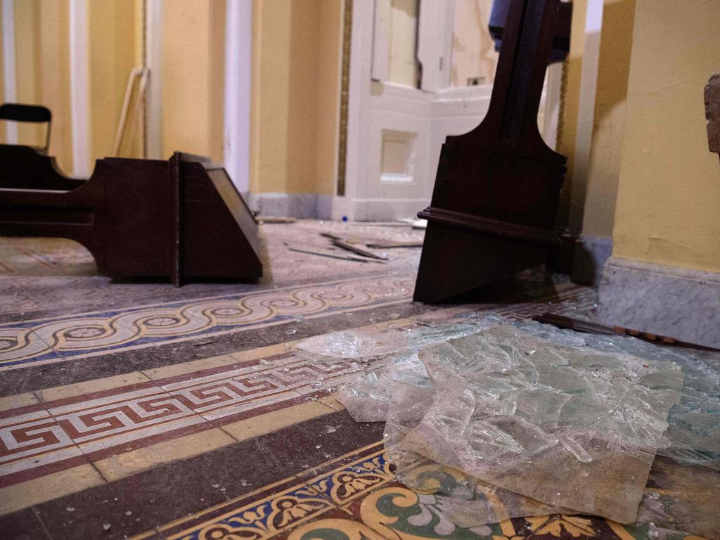 Overturned furniture and broken glass litter a hallway on Capitol Hill following the extraordinary riots. Picture: Nicholas Kamm/ AFP