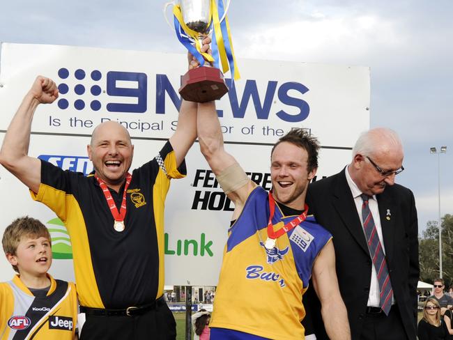 Mick Fogarty and Craig Anderson lift the premiership cup.