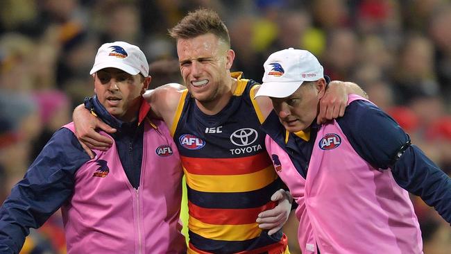 Brodie Smith in pain as he is helped from the field. Picture: AAP