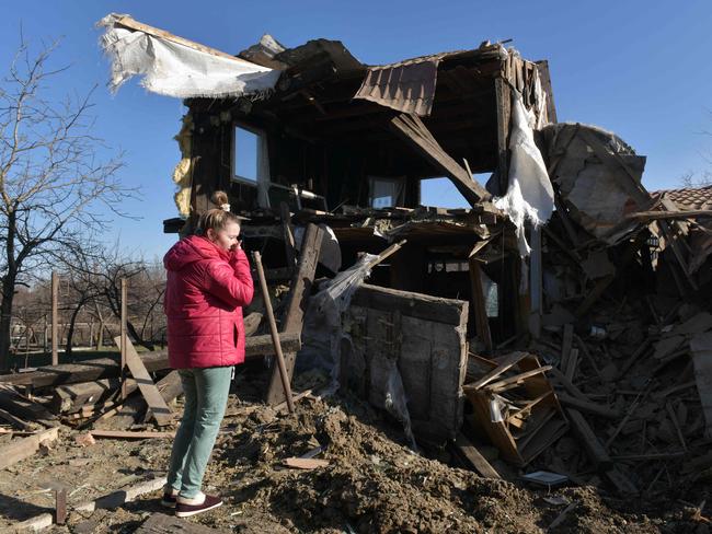 A woman stands by her destroyed house following recent shelling in Uglegorsk in the Donetsk region, Russian-controlled Ukraine. Picture: AFP