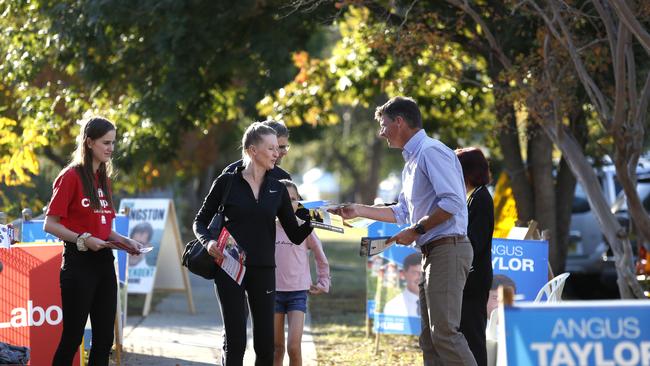 MACARTHUR CHRONICLE/AAP. Hume MP Angus Taylor hands out how to vote pamphlets at Camden Public School polling booth, Saturday, 18th May 2019. (AAP IMAGE / Robert Pozo).