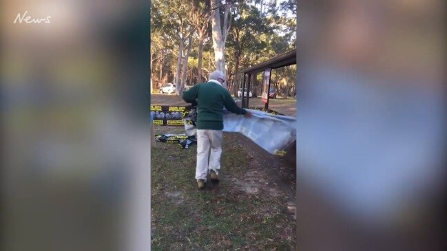 Man tears down election material in the Liberal seat of Gilmore